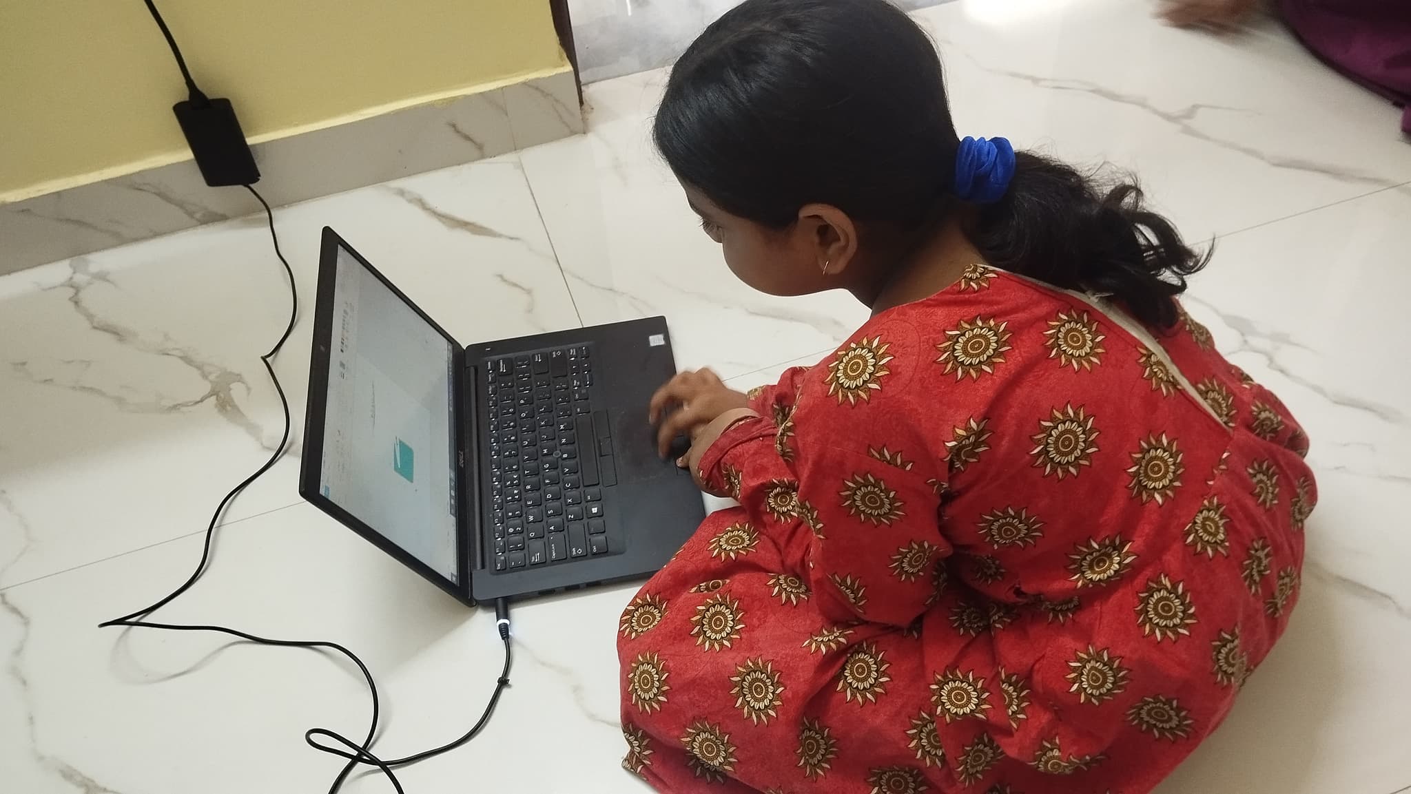 Student coding on a laptop for an AI project